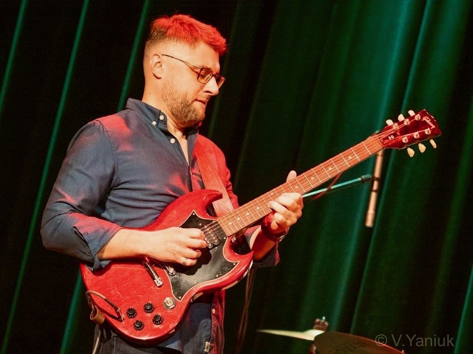Paul under red stage lights